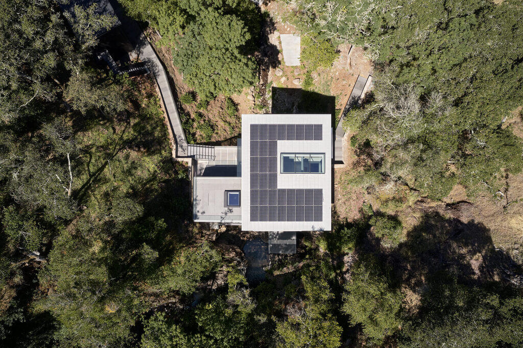 An aerial view of a Suspension House with a solar panel on the roof 