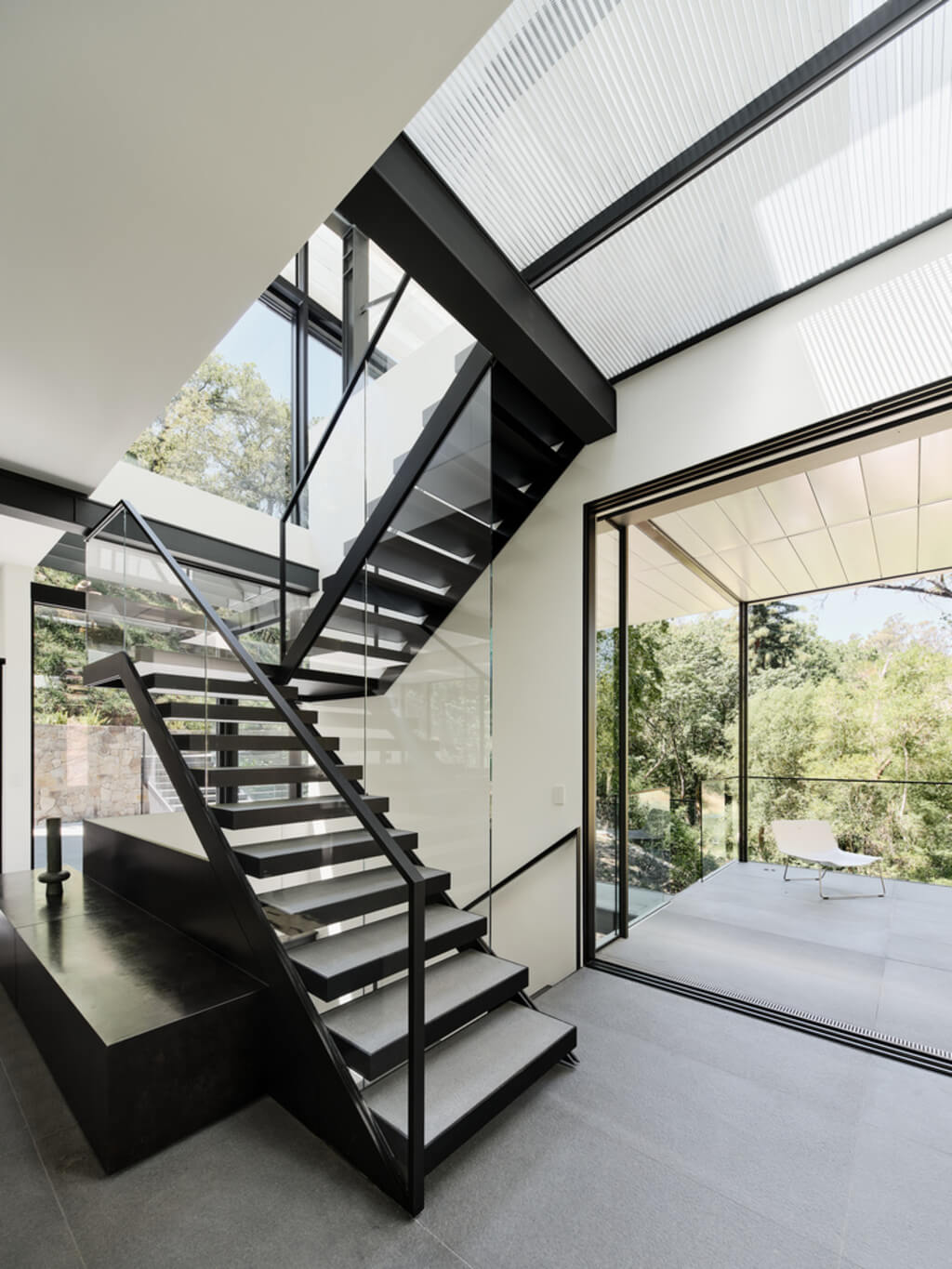 A black and white staircase in a 
Suspension House by Fougeron Architecture