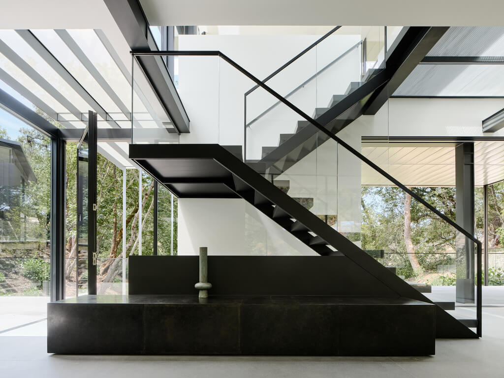 A black and white staircase inside of 
Suspension House by Fougeron Architecture