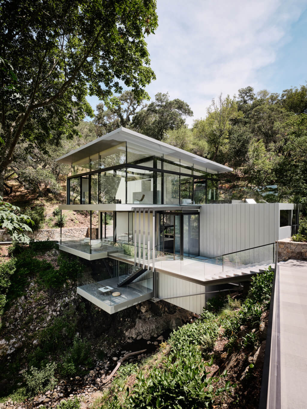 Suspension House on a hillside with trees in the background