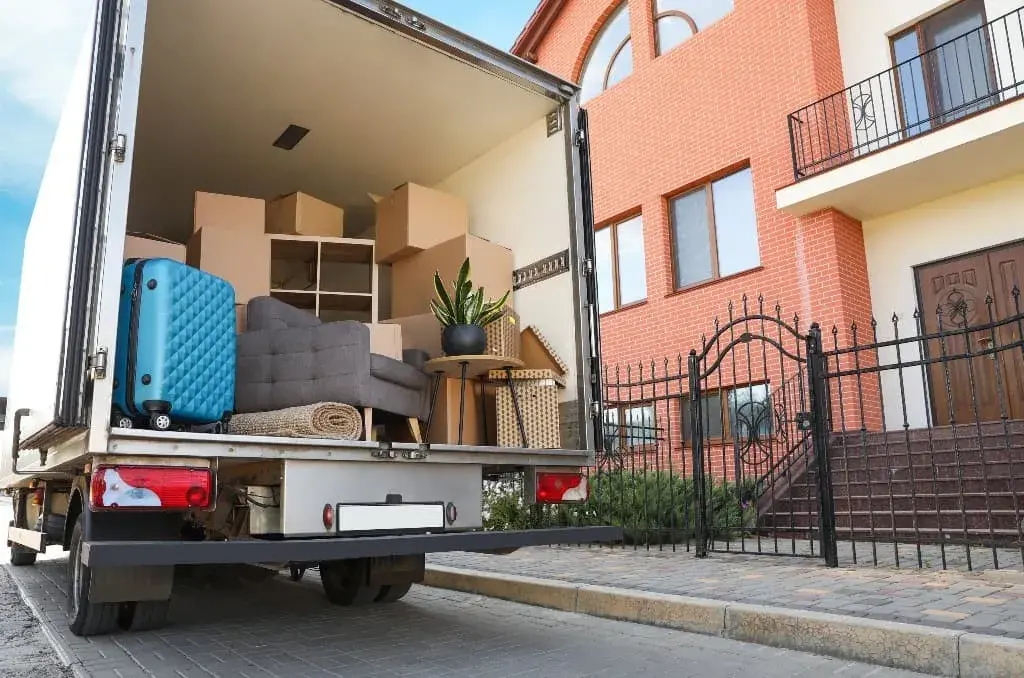 The back of a moving truck loaded with furniture
