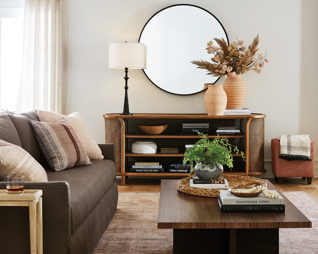 A living room filled with furniture and a mirror
