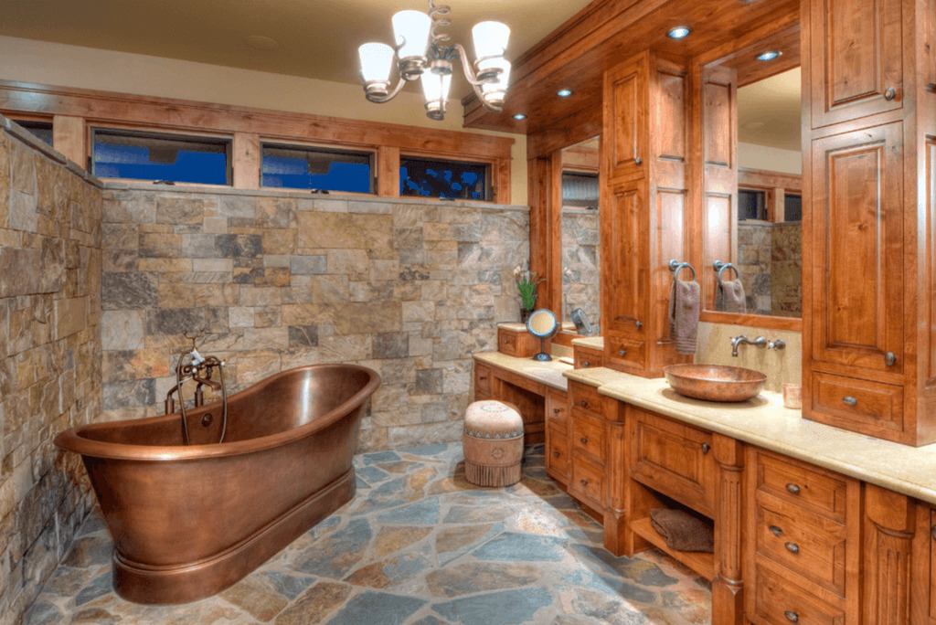 Copper bathtub in a cohesive natural bathroom