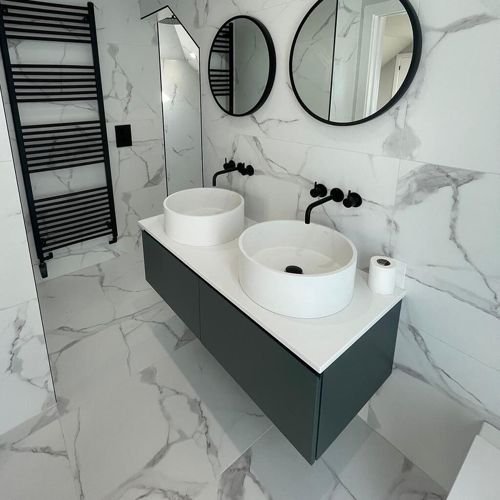 Floating vanities with big tiles in bathroom