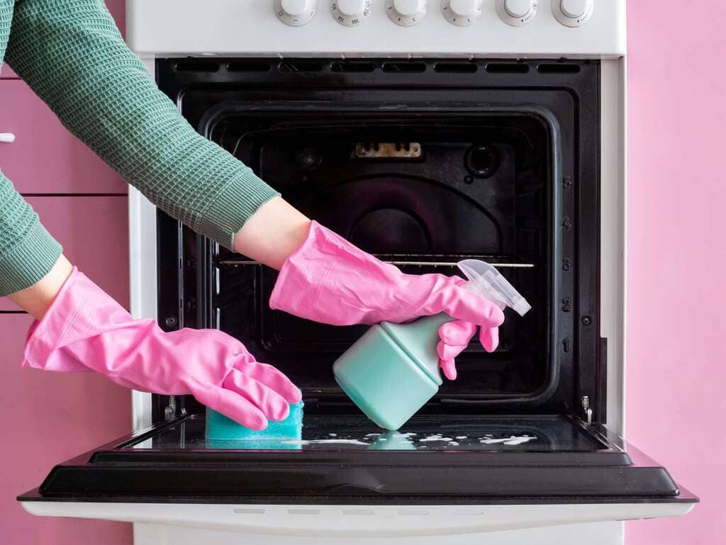 Women Cleaning Oven Using Scrub