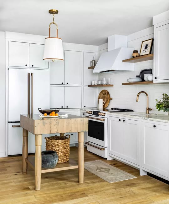 Fully White Kitchen having Small Wooden Table