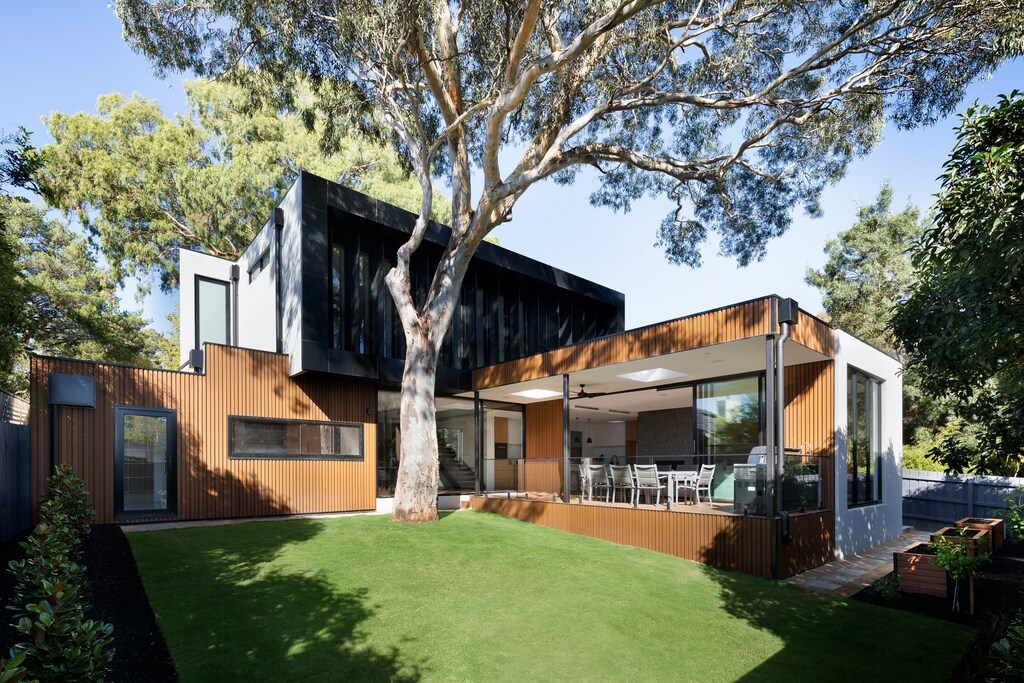 brown wooden house near green trees