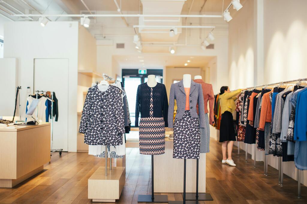 mannequins in trendy clothes placed in stylish shop
